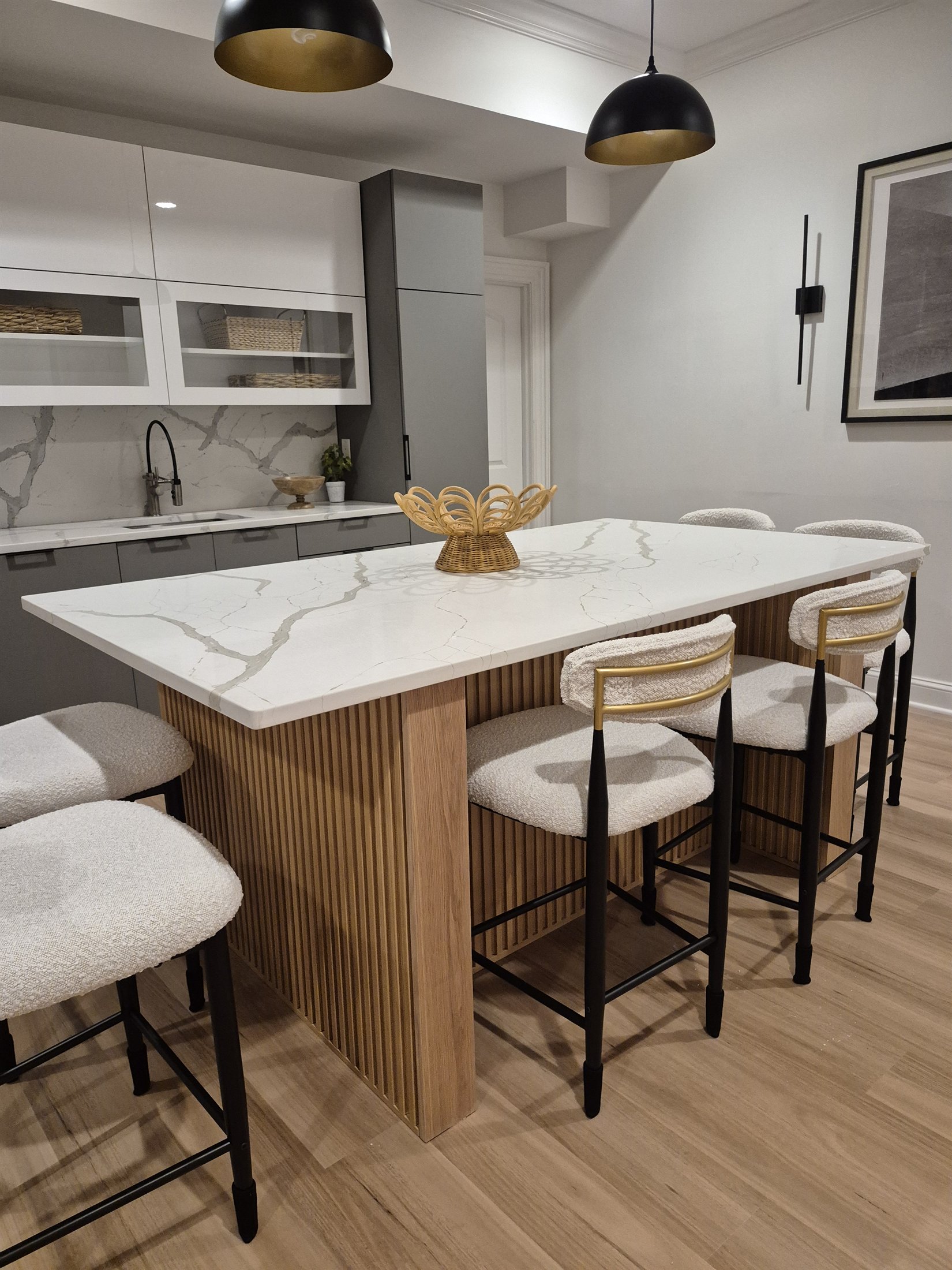 Custom fluted white-oak kitchen island and fitted cabinetry